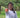Filipino woman holding out jar of coconut oil